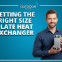 Man in blue shirt holding a plate heat exchanger with Outdoor Boiler branding, illustrating the importance of correct plate heat exchanger sizing for efficiency.