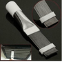 Cleaning brush with bristle head and white handle on a black background.